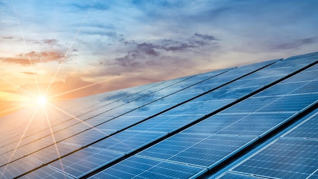 Image showing sun striking solar panels on a roof at sunset. DOAS Token renewable energy projects