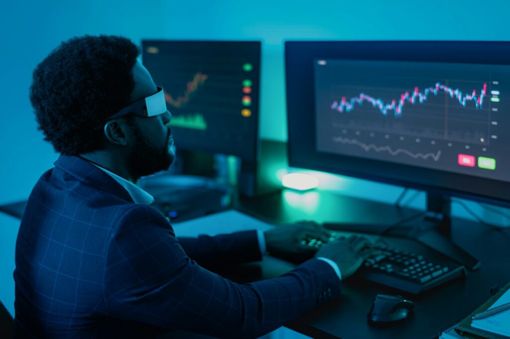 Financial analyst working on NFT blockchain technology with virtual reality glasses in office